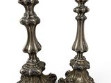 pair of antique silver candlesticks on a white background