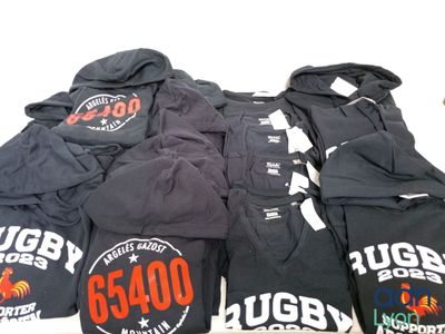 a pile of t - shirts that are on a table
