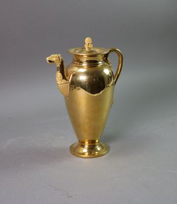 a gold vase that is sitting on a table
