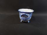 a small blue and white bowl sitting on a table