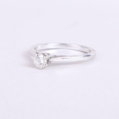 a white gold engagement ring with a single diamond