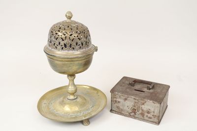 a small metal object with a lid and a small box