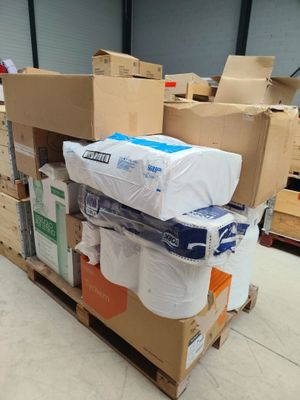 many rolls of toilet paper on a pallet in a warehouse