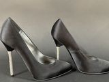 pair of women ' s black satin high heeled shoes on a gray background