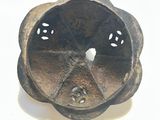a small metal object that is on a white surface