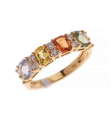 un gros plan d'une bague en or jaune sertie de pierres de différentes couleurs
