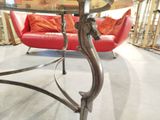 a glass table with a horse head on it in a room