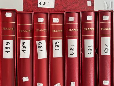 several red books are lined up on a shelf in a library