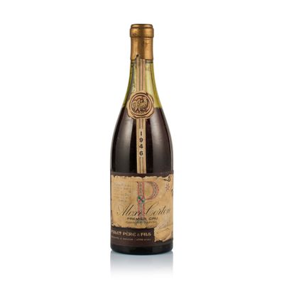 a bottle of wine sitting on top of a white table