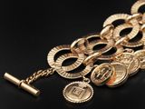 a close up of a bunch of gold coins on a black surface