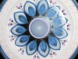 a blue and white plate with a flower design on it