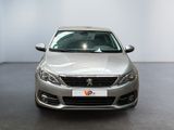 the front of a silver car is parked in a showroom