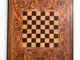 a close up of a wooden chess board on a white background