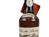 an old bottle of calvados with a tag on it