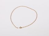 a gold chain bracelet with a tiny star charm