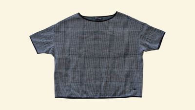 the shirt is blue and white checkered with a black collar
