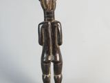 an image of a wooden statue of a man with a hat on his head