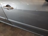 a silver car that is parked in a garage