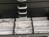 a black filing cabinet that has a bunch of glasses in it