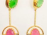 a pair of earrings with green and pink stones on them
