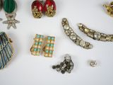 many different types of jewelry on a white surface