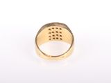 a close up of a gold ring on a white surface