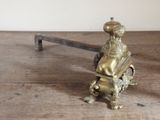 a small metal object sitting on a wooden table