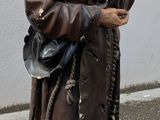 une statue représentant un homme tenant un couteau et une fourchette
