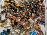 a tray of assorted jewelry sitting on a table