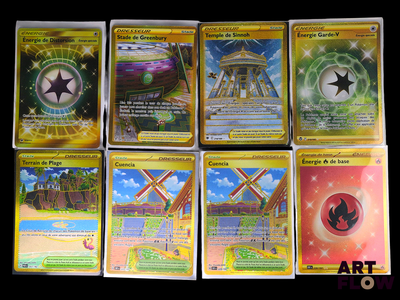 several pokemon cards sitting on top of each other on a table