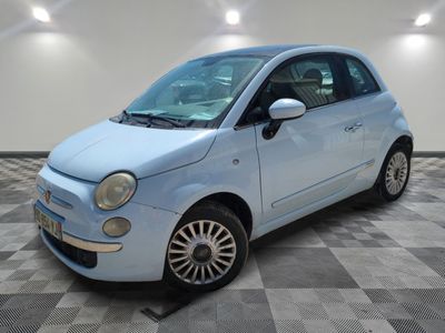 a picture of a small blue car parked in a garage