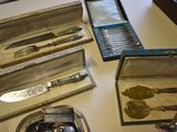 many different types of silverware on a table