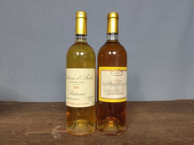 two bottles of wine that are sitting on a table