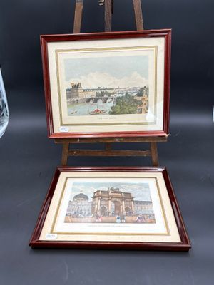 tableau posé sur un chevalet, avec une vue de ville en arrière-plan