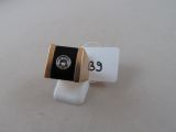 a black and gold ring with a diamond on it