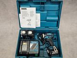 a blue tool box with a drill and a hammer inside of it