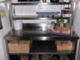 a kitchen with a stainless steel counter top and shelves