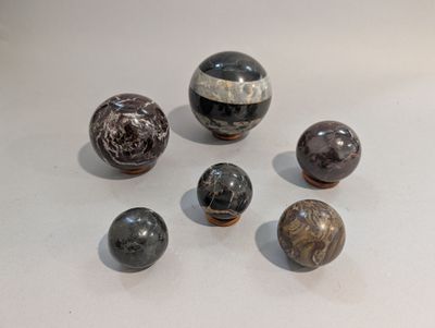 several marble balls are arranged on a white surface