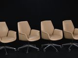 four office chairs are lined up in a row on a black background