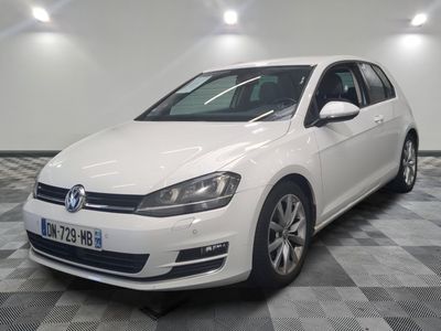 the white volkswagen golf is parked on a checkered tile floor