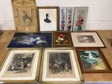 many framed pictures on a table with pictures on it