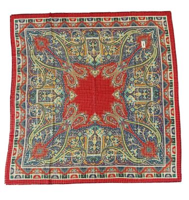 a red, blue and green square rug with a floral design on it