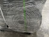 several rolls of wire wrapped in plastic sitting on top of a pallet