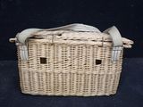a wicker basket with a cloth inside of it