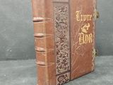 a brown book with gold writing on it sitting on a table