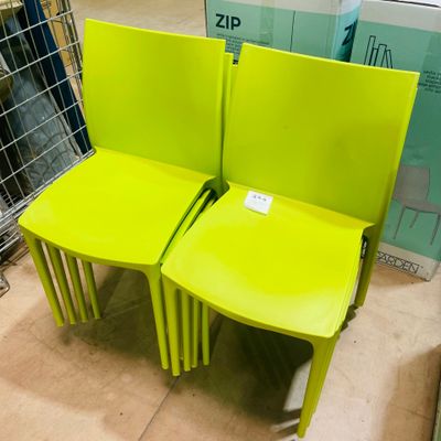 two yellow chairs sitting next to each other in a store