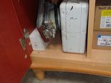 a white refrigerator sitting inside of a cabinet in a room