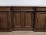 a close up of a wooden cabinet on a wooden floor