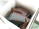a box full of old books sitting on the floor