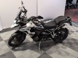 bmw motorcycle parked on a checkered floor in a showroom